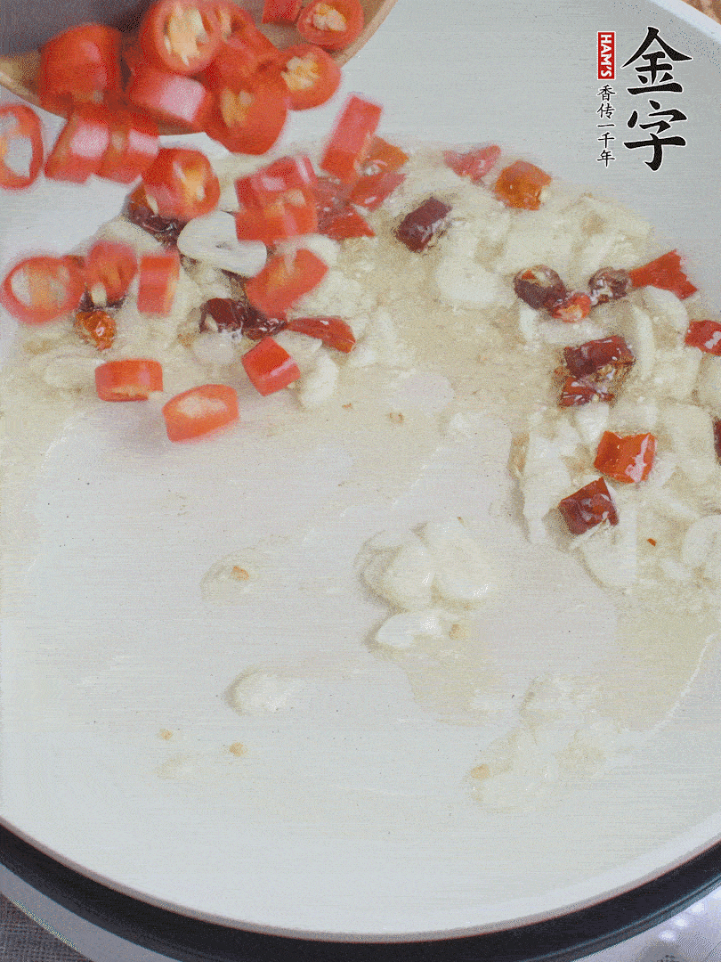 油6成熱，下蒜末、干紅辣椒煸炒，出香味后再放美人椒、香腸。